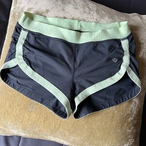 Lululemon Athletica Black and Green Athletic Shorts with Curved Hem